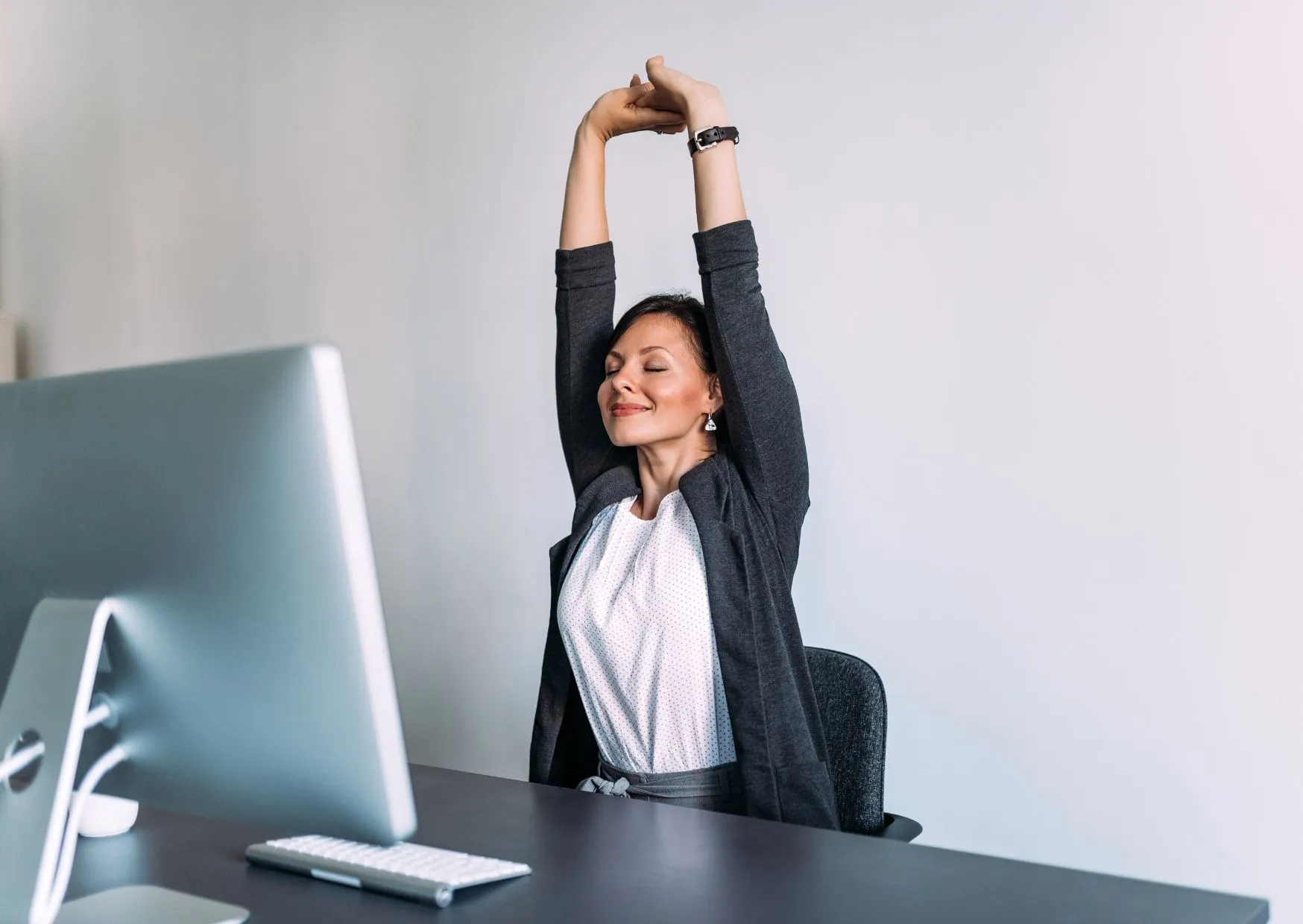 Office workers performing stretching exercises during workplace break